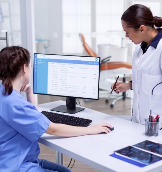 Dentist and dental team member reviewing calendar