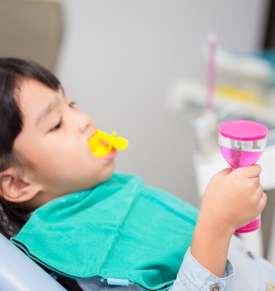 Child receiving fluoride treatment