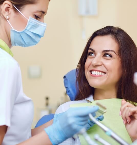 Dentist and dental patient discussing cosmetic dental bonding