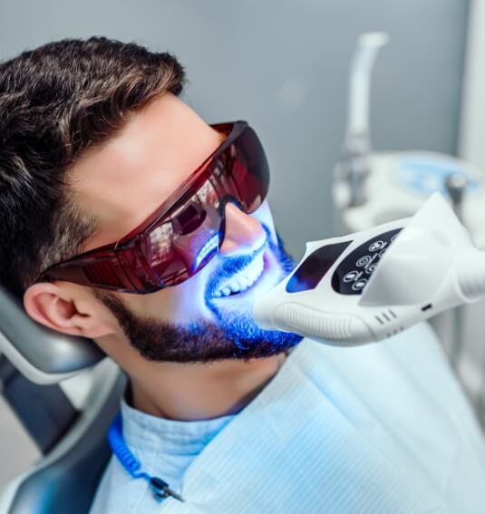 Dental patient receiving teeth whitening