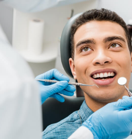 Man smiling after soft tissue laser dentistry