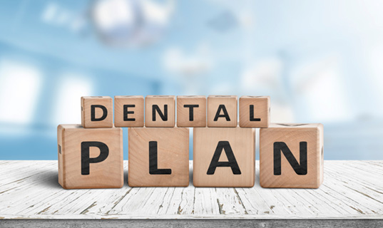 Wooden blocks spelling out “Dental Plan”
