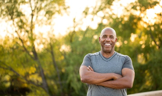 Man smiling while on a walk outside