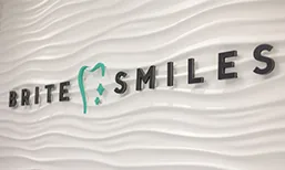 Brite Smiles logo on a white wall