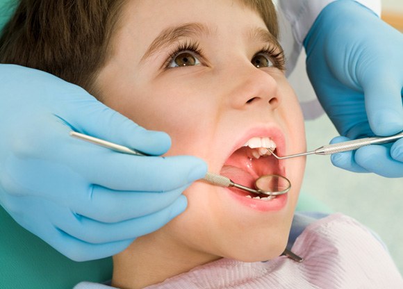 Young patient in Mount Prospect smiling in the dentist chair