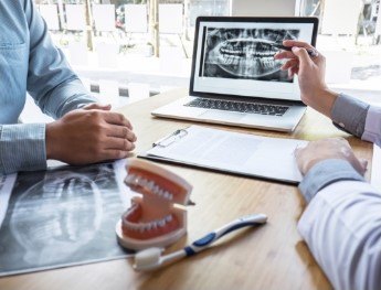 dentist showing patient x rays in Des Plaines