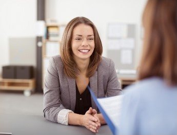 patient smiling at receptionist in Des Plaines