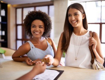 patients smiling at receptionist desk in Des Plaines