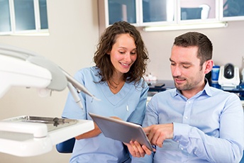 Patient and dentist looking at a tablet