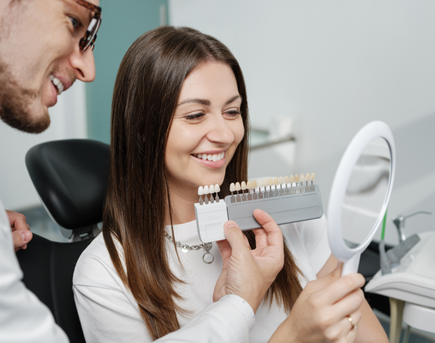 Dentist showing patient veneer options