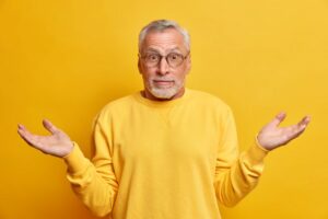 Man wondering if he can brush his dentures while wearing them